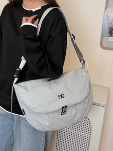 Light gray waterproof nylon messenger bag with adjustable wide strap and black logo