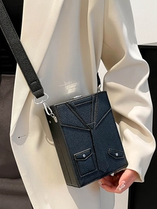 Unique blazer-style box crossbody bag in black lychee grain leather with silver hardware