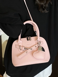 Pink lychee grain shell bag with heart charm and silver rivets, crossbody style