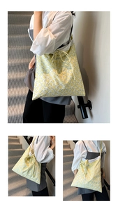 Detailed close-up of yellow floral tote bag with lace trim and bow knot detail