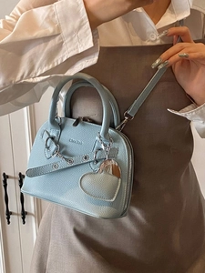 Stylish light blue shell-shaped leather handbag with silver chain and heart charm detail