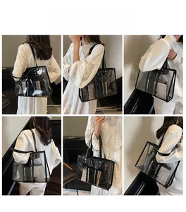 Detailed view of clear PVC tote bag with black trim and inner pouch shown on a model