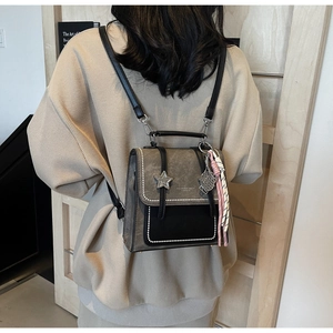 Detail of vintage star-studded small backpack with pearl trim and woven tassel