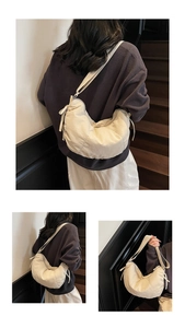 Detail view of beige nylon crescent tote with adjustable wide strap for casual wear