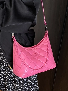 Pink quilted leather crossbody bag with chain strap shown on a model for daily wear