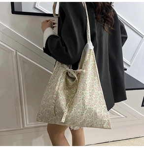 Detail of floral tote bag showing delicate pink flower patterns and cute ribbon bow design