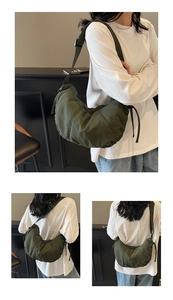 Close-up of military green crescent bag with adjustable strap and side drawstring detail
