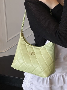 Quilted light green chain baguette bag with elegant diamond stitching and turn-lock closure