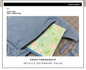 Détail du sac croissant en denim bleu clair montrant la poche externe et la tirette tressée