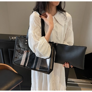 Modern transparent PVC tote bag with black inner leather pouch shown on shoulder