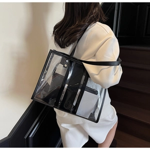 Transparent tote bag with black trim and inner pouch shown from a side view