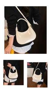 Detail of cream crescent hobo bag showing refined leather texture and gold logo branding