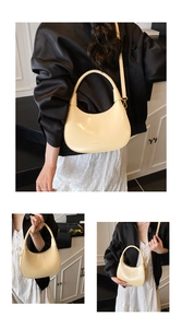 Detailed view of beige crescent bag showing smooth leather texture and logo detail