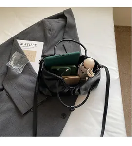 Spacious interior of the black pleated PU leather bucket bag with daily essentials inside