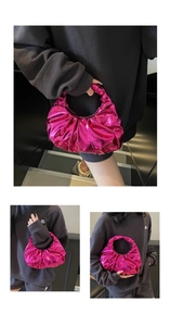 Detailed view of glossy fuchsia pleated dumpling bag with metallic leather texture