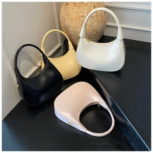 Detailed collection of crescent underarm bags in black, cream, white, and pink leather