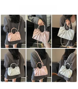 Detailed views of pink and silver pleated bucket bag in crossbody and handheld styles