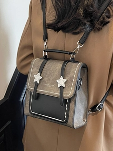 Retro brown and black two-tone backpack with silver star metal buckles and contrast stitching