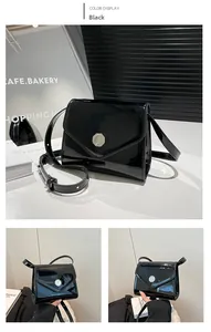 Détail du sac bandoulière en cuir verni noir avec un fermoir magnétique rond argenté