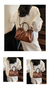 Close-up of pleated dark brown oil wax leather handbag with retro texture and strap