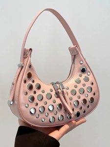 Pink crescent underarm bag with decorative silver metal studs in a stylish design