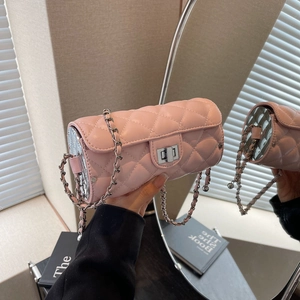 Détail du sac cylindre matelassé rose clair avec chaîne argentée et fermoir pivotant