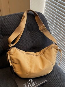 Minimalist ginger crescent tote bag with textured nylon and adjustable shoulder strap