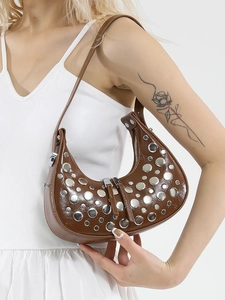 Brown moon-shaped shoulder bag featuring decorative silver studs and a sleek finish