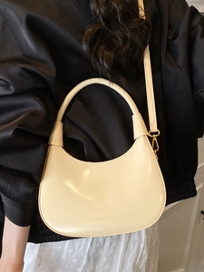 Fashionable off-white crescent-shaped leather underarm bag with gold metal buckle