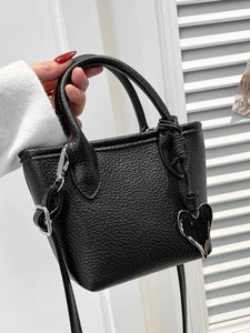Chic black litchi textured mini handbag for women with metallic heart pendant and strap