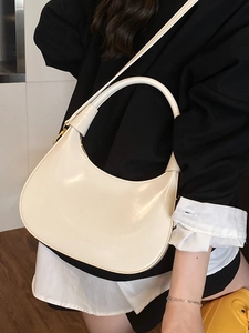 Minimalist off-white crescent underarm bag in smooth leather for stylish commuting
