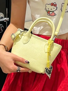 Chic light yellow textured mini tote bag with heart charm and adjustable shoulder strap