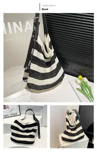Detail of black and white striped knitted tote bag with adjustable leather strap