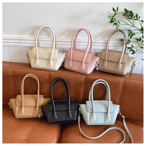 Detailed display of mini bucket bags in six colors arranged on a stylish sofa