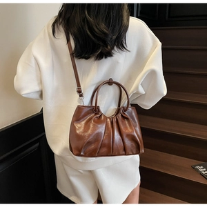 Brown oil wax leather handbag with pleated cloud design and detachable shoulder strap