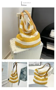 Detailed knit texture of yellow and white striped beach tote with leather strap