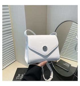Détail du mini sac en cuir verni blanc avec boucle en cire argentée et bandoulière