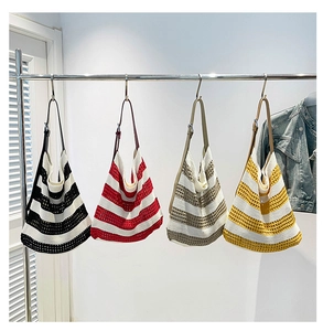 Detail showing adjustable PU leather straps and hollow knit texture on tote bags