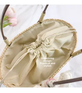Close-up of woven straw bucket bag showing drawstring closure and beige fabric lining