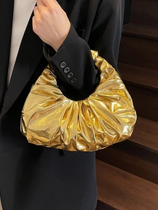 Chic metallic gold ruched handbag with high-shine finish and pleated cloud shape