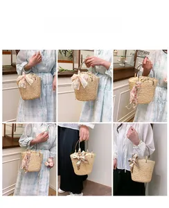 Detail of woven straw bucket bag showing bamboo handles and floral scarf decoration