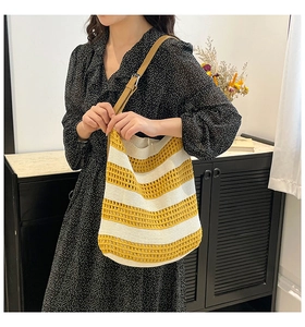 Detail of yellow and cream striped crochet tote bag with adjustable faux leather strap