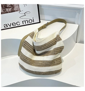 Detail of the knit hollow-out pattern and adjustable leather strap of the tote bag