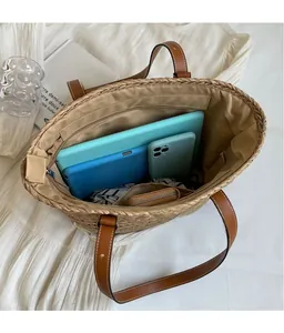 Interior view of large straw tote bag showing spacious capacity for tablets and essentials