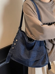 Deep blue denim hobo bag with silver buttons and wide shoulder strap for daily commuting