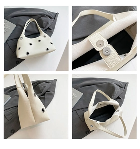 Detail view of white lychee texture leather shoulder bag with silver metal eyelets and magnetic buckles