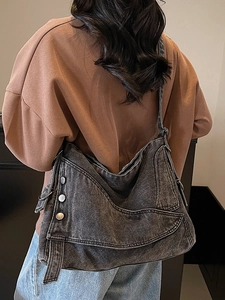 Washed denim slouchy tote bag for women featuring large capacity and retro metal buckle style