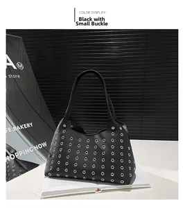 Detail shot of the black lychee pattern leather handbag featuring silver metal eyelets