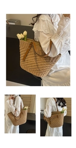 Close-up of woven straw tote bag with brown leather handles and decorative white tulips