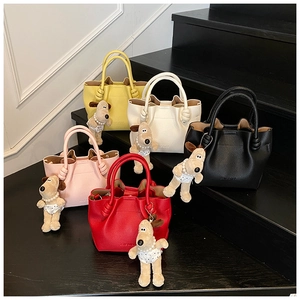 Litchi pattern bucket bags in five colors featuring knot handles and cute puppy charms